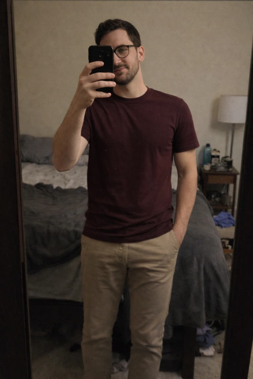 Weak pose example showing Ryan in a dim mirror selfie with part of his face covered by a phone